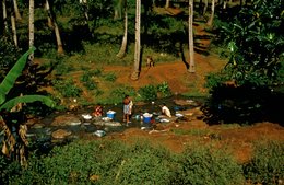 Coconut-palms;-Comoros-Archipelago;-Daily-life;-France;-High-angle-view;-Indian-Ocean;-Kaleidos;-Kaleidos-images;-La-parole-à-limage;-Laundry;-Laurent-Abad;-Mayotte;-Red-earth;-Stories-Pictures;-Stream;-Washing;-Women